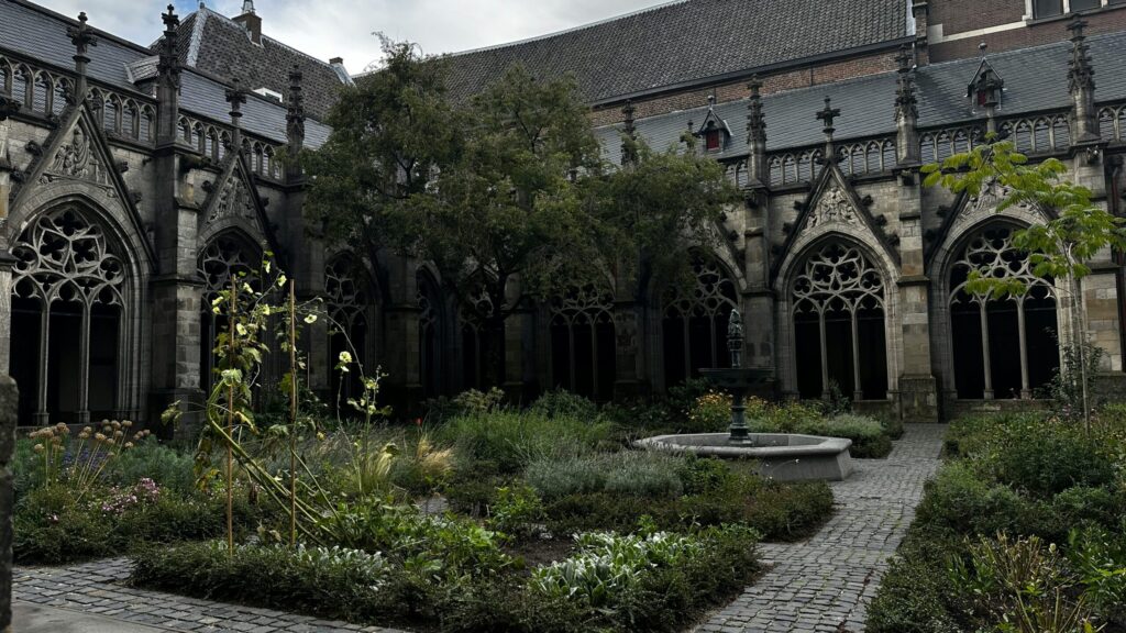 Courtyard of Gothic style building with garden.
